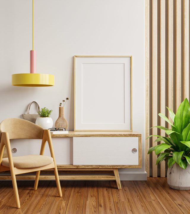 Mockup frame on cabinet in living room interior with chair,White wall background.3d rendering